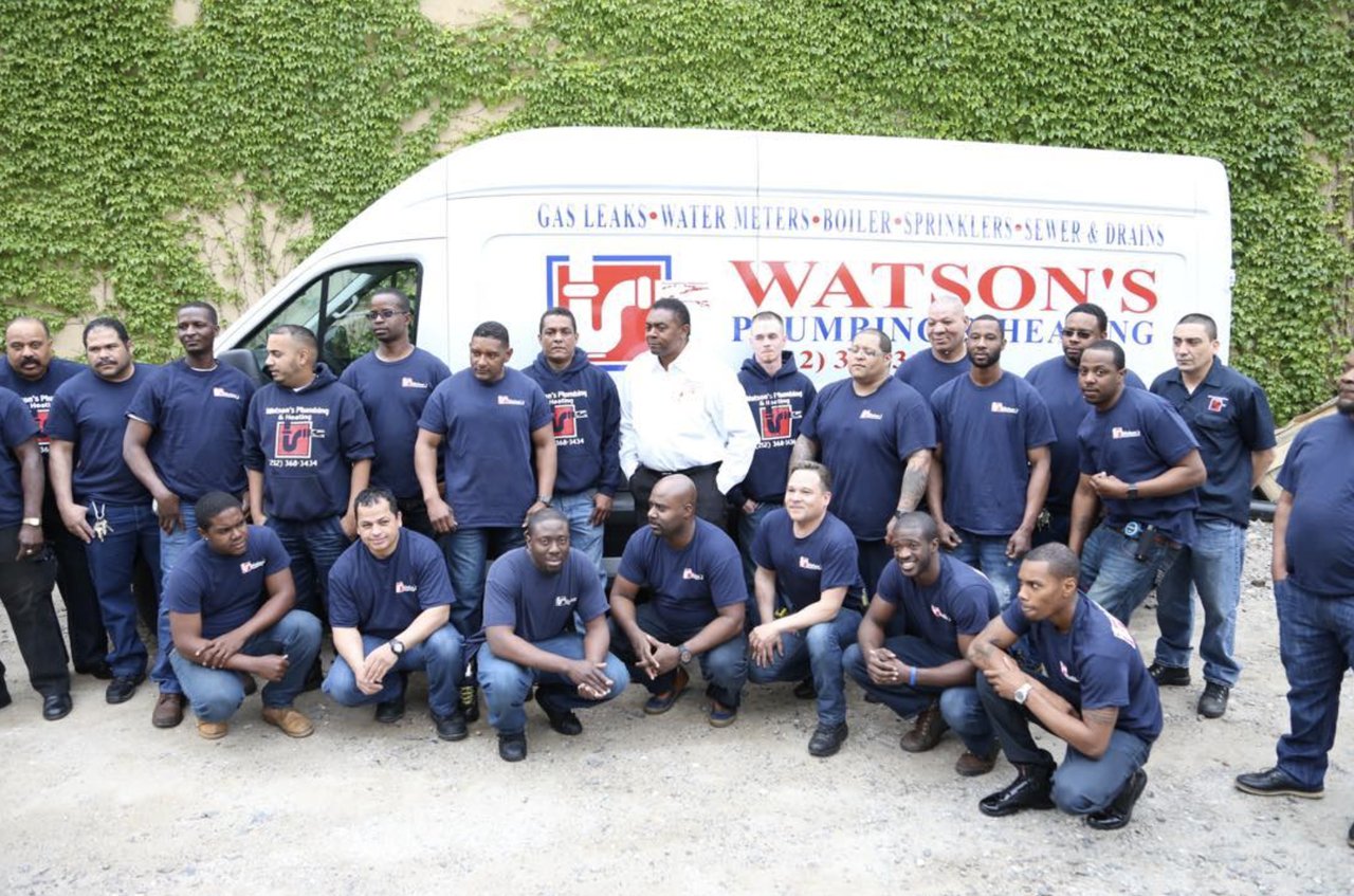 The Watson's Plumbing, Heating & Building Services team in front of a company truck
